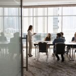 Wide shot of multiethnic business team talking at meeting table