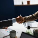 Business partners shaking hands after closing a deal