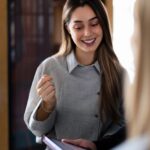 Smiling Businesswoman Discussing Project With Colleague
